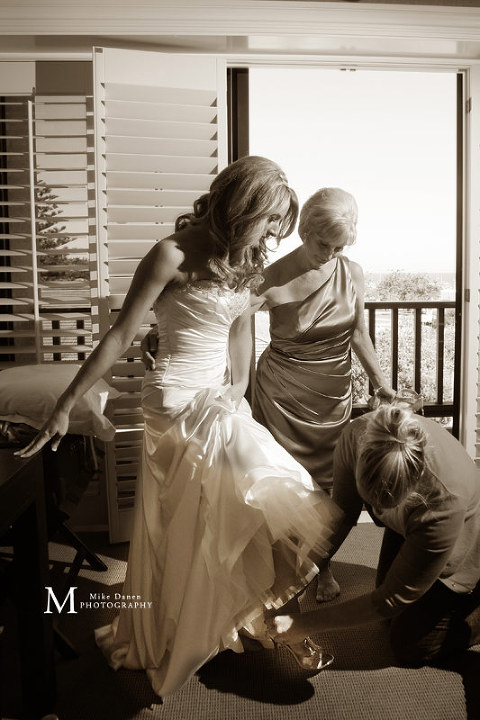 Bridesmaids helping with shoes