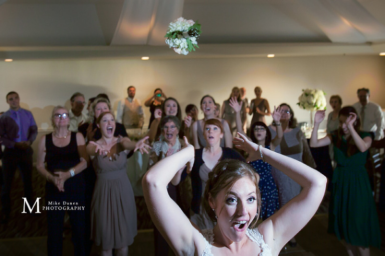 Seascape bride tossing bouquet